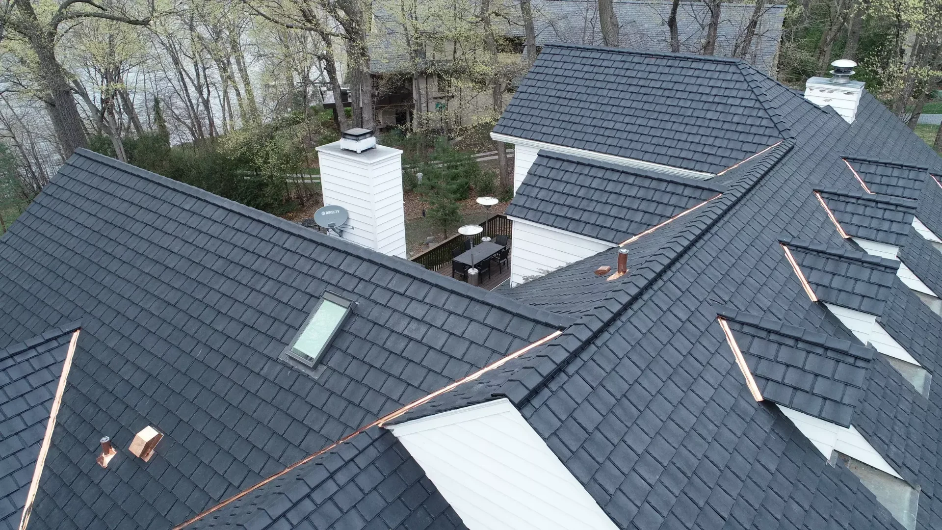 Slate roof with copper valleys and multi-pitch dormers